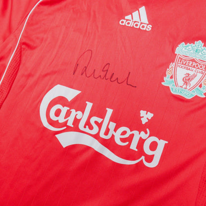 Close-up of the adidas logo, Liverpool crest, Carlsberg sponsor and signature on the chest