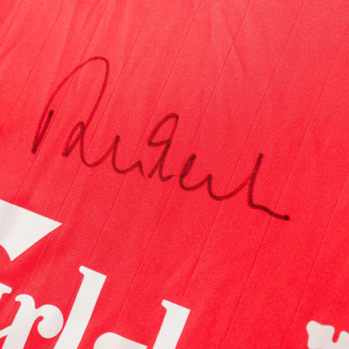 Close-up of the handwritten signature on the shirt chest