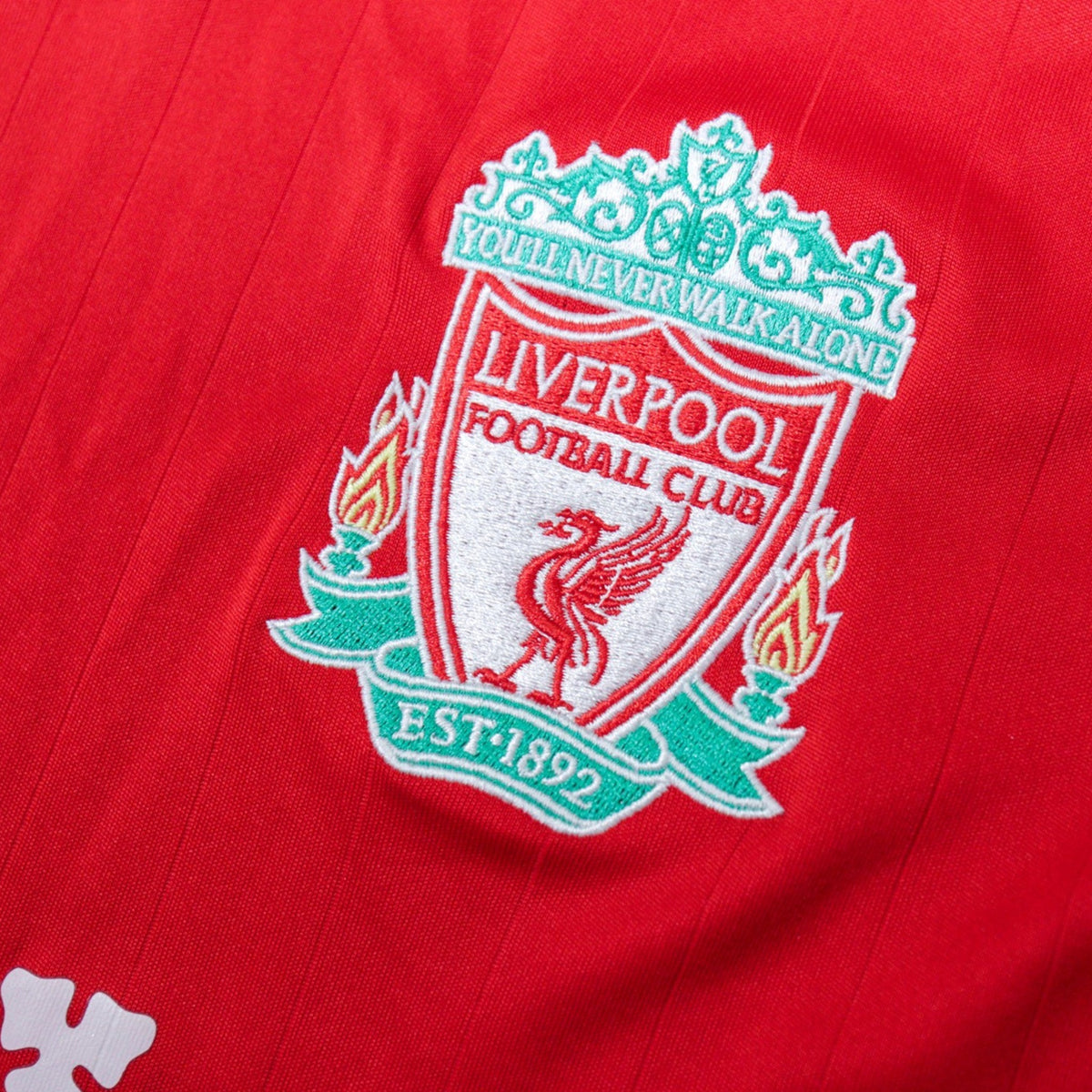 Close-up of the embroidered Liverpool crest on the chest
