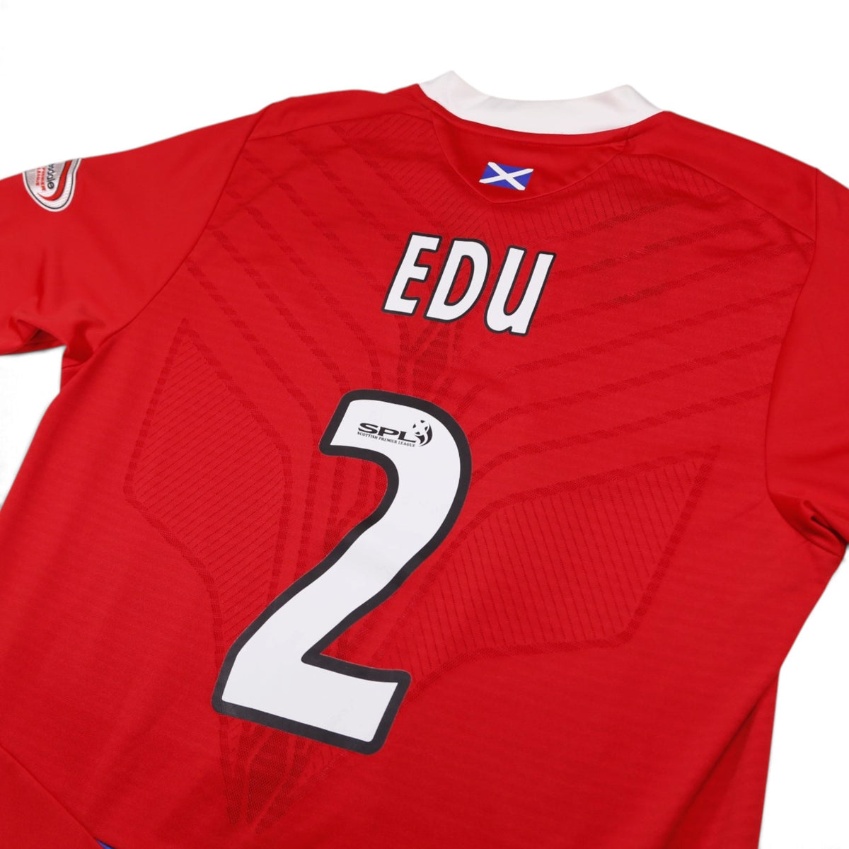 Close-up of Rangers third shirt back print showing Edu #2 and Scotland flag detail