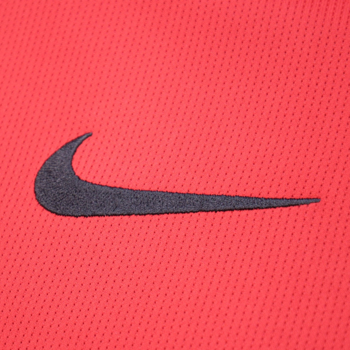 Close-up of the Nike swoosh logo on the shirt sleeve