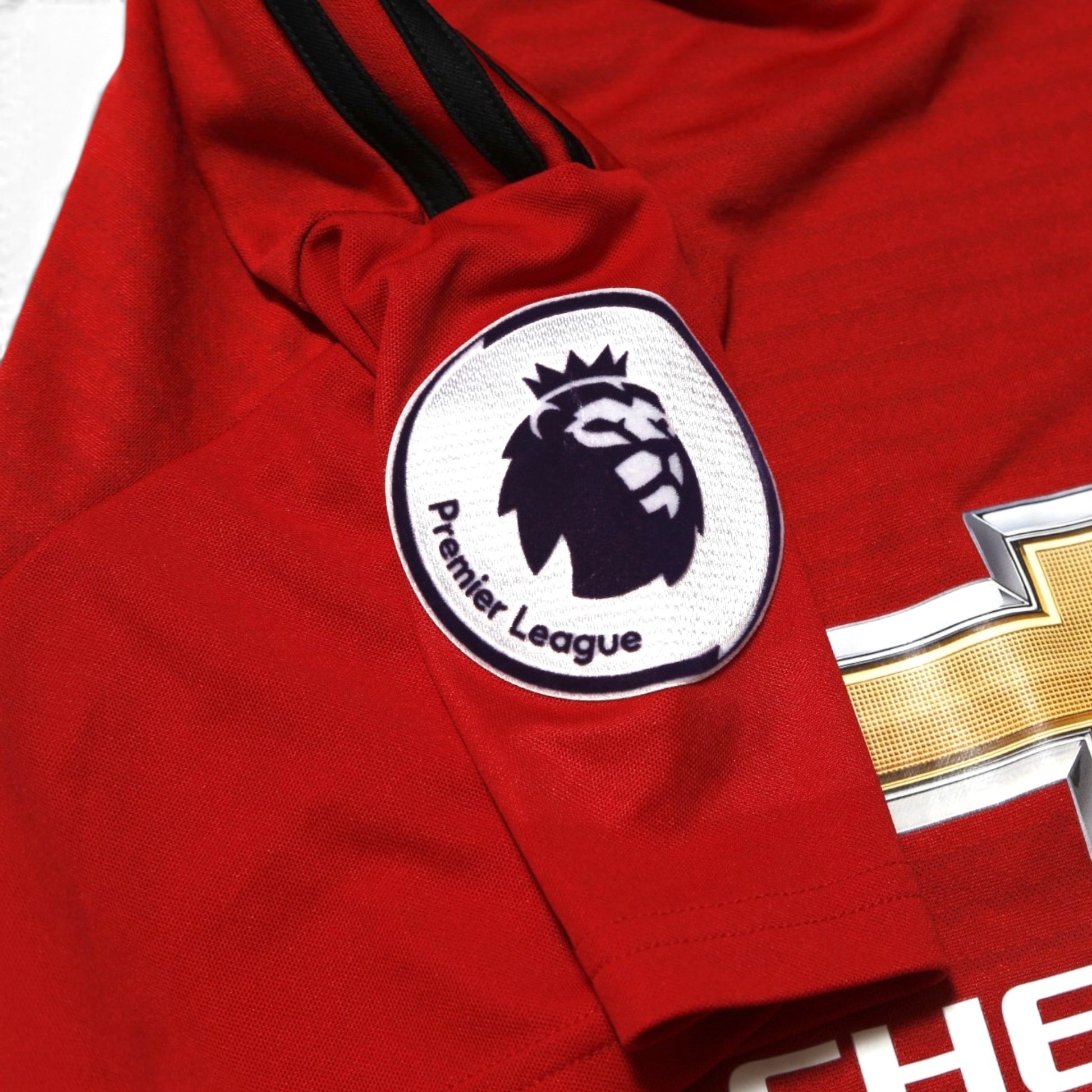 Close-up of Premier League sleeve badge on Manchester United home shirt