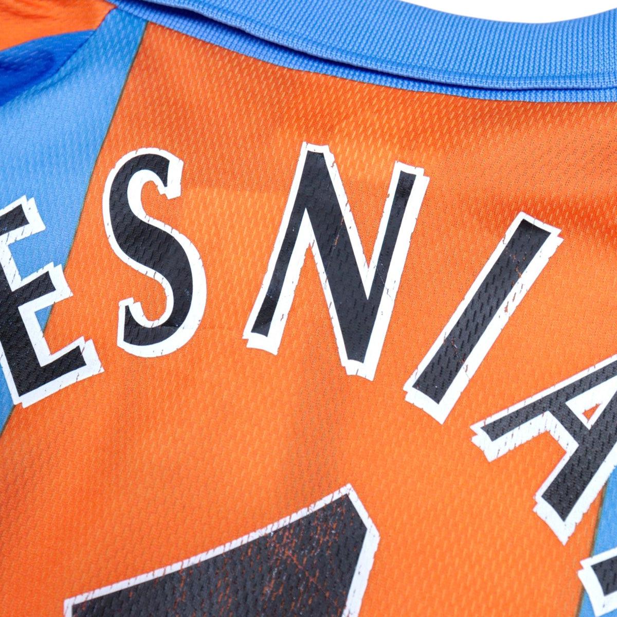 Close-up of the Sesniak name print showing surface wear