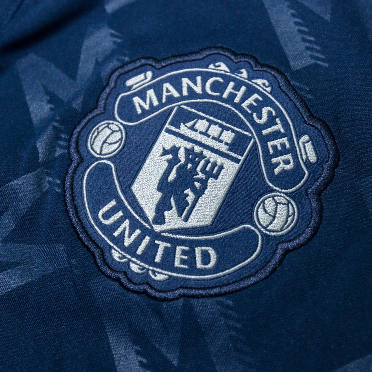 Close-up of embroidered Manchester United crest
