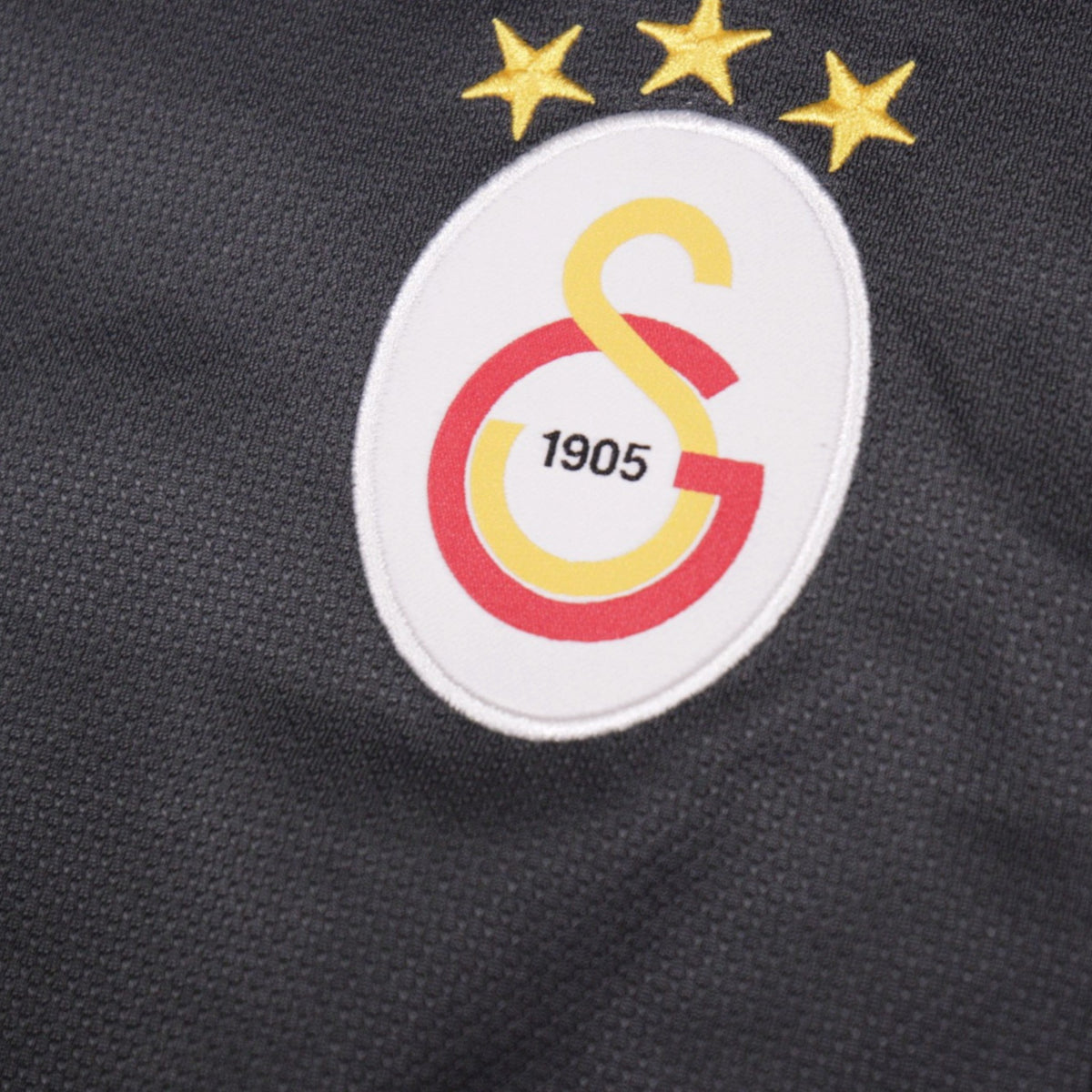 Close-up of the embroidered Galatasaray crest with 1905 founding date