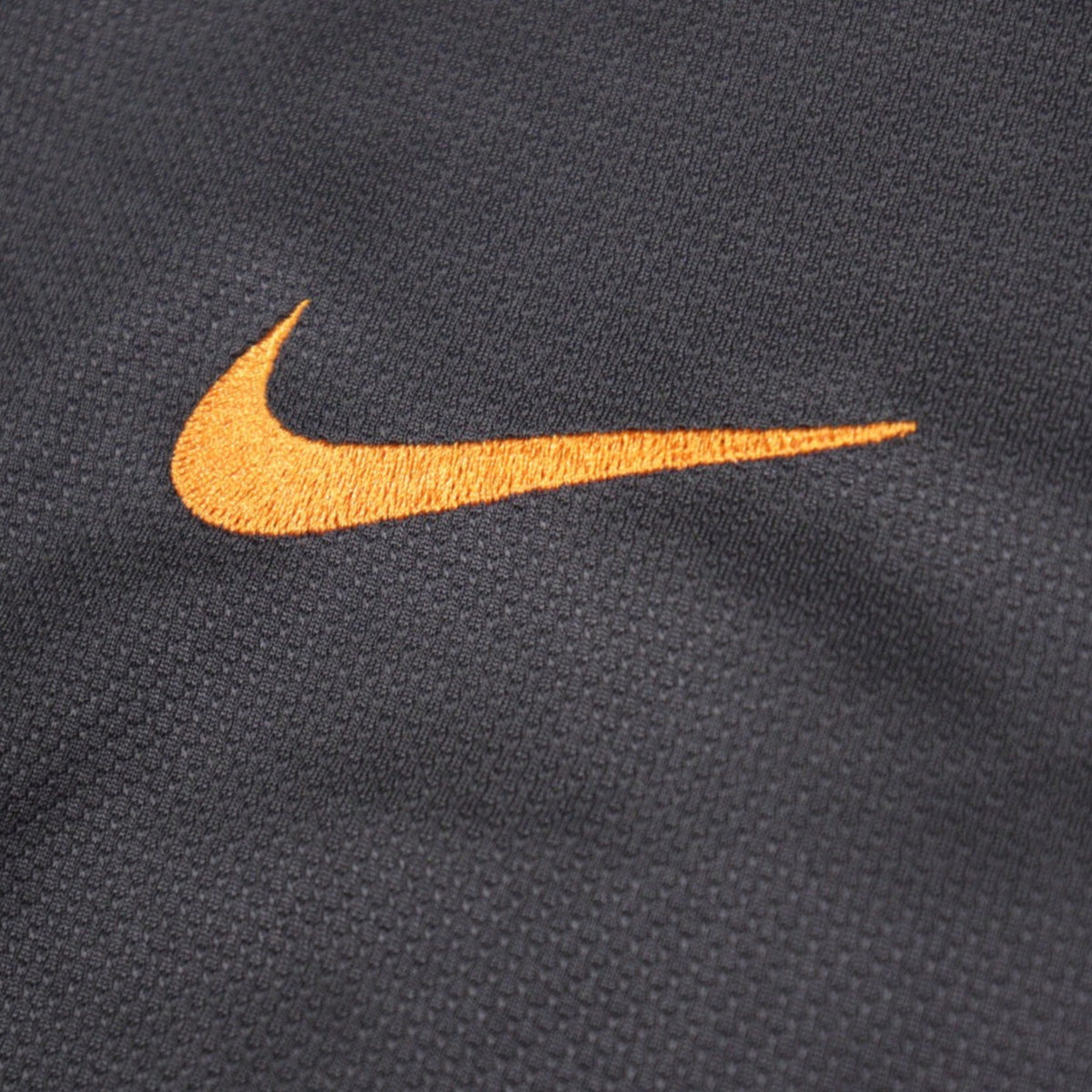 Close-up of the embroidered Nike swoosh on the chest