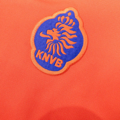 Detailed close-up of the blue and orange KNVB crest on the chest