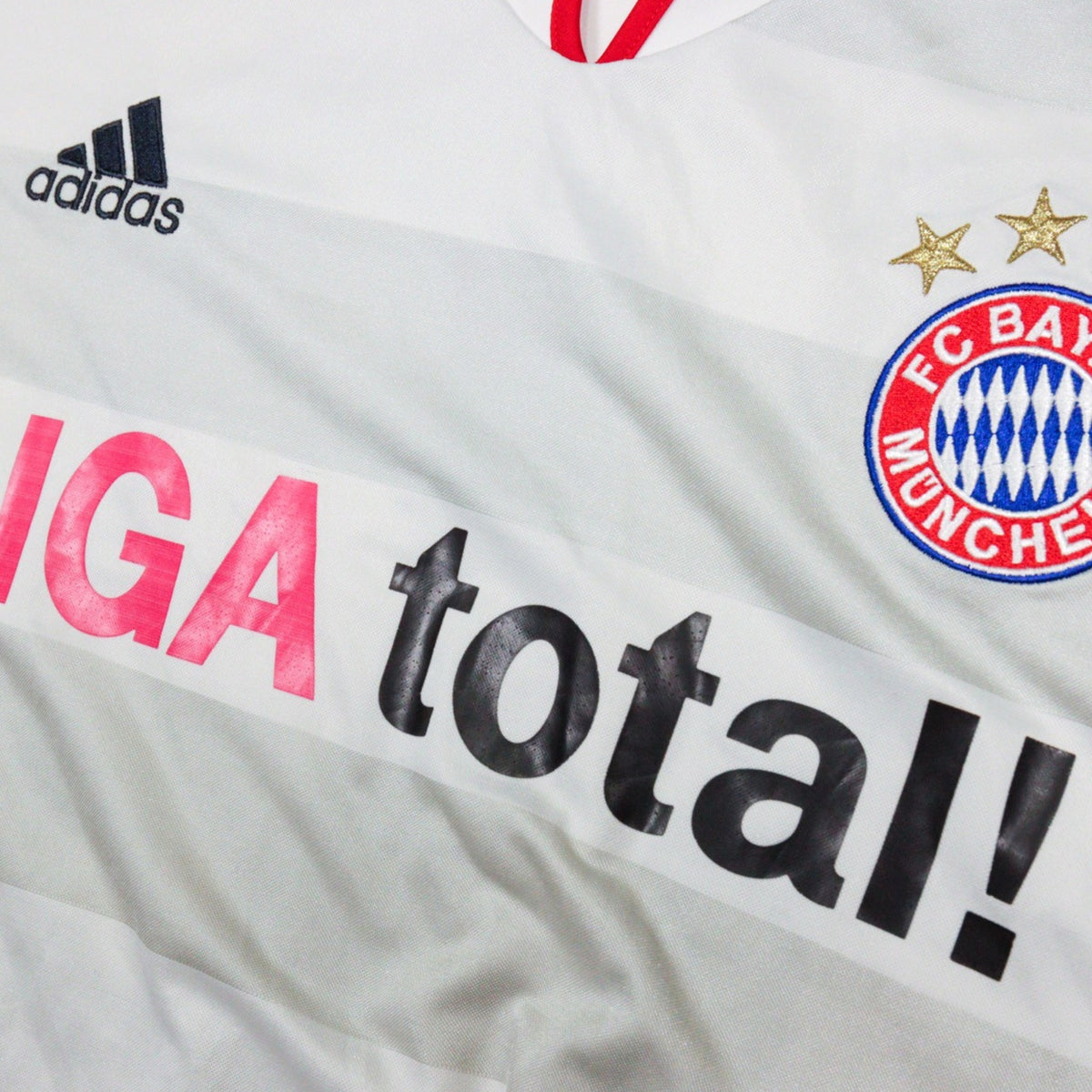 Close-up of adidas logo, crest and LIGA total! sponsor on chest