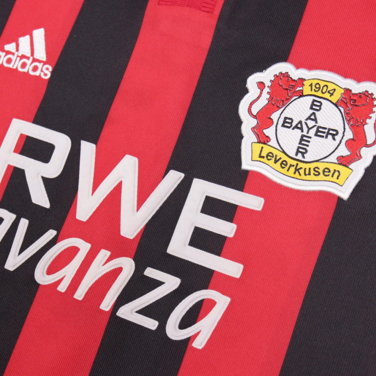 Close-up of the Bayer Leverkusen crest and adidas logo on the shirt