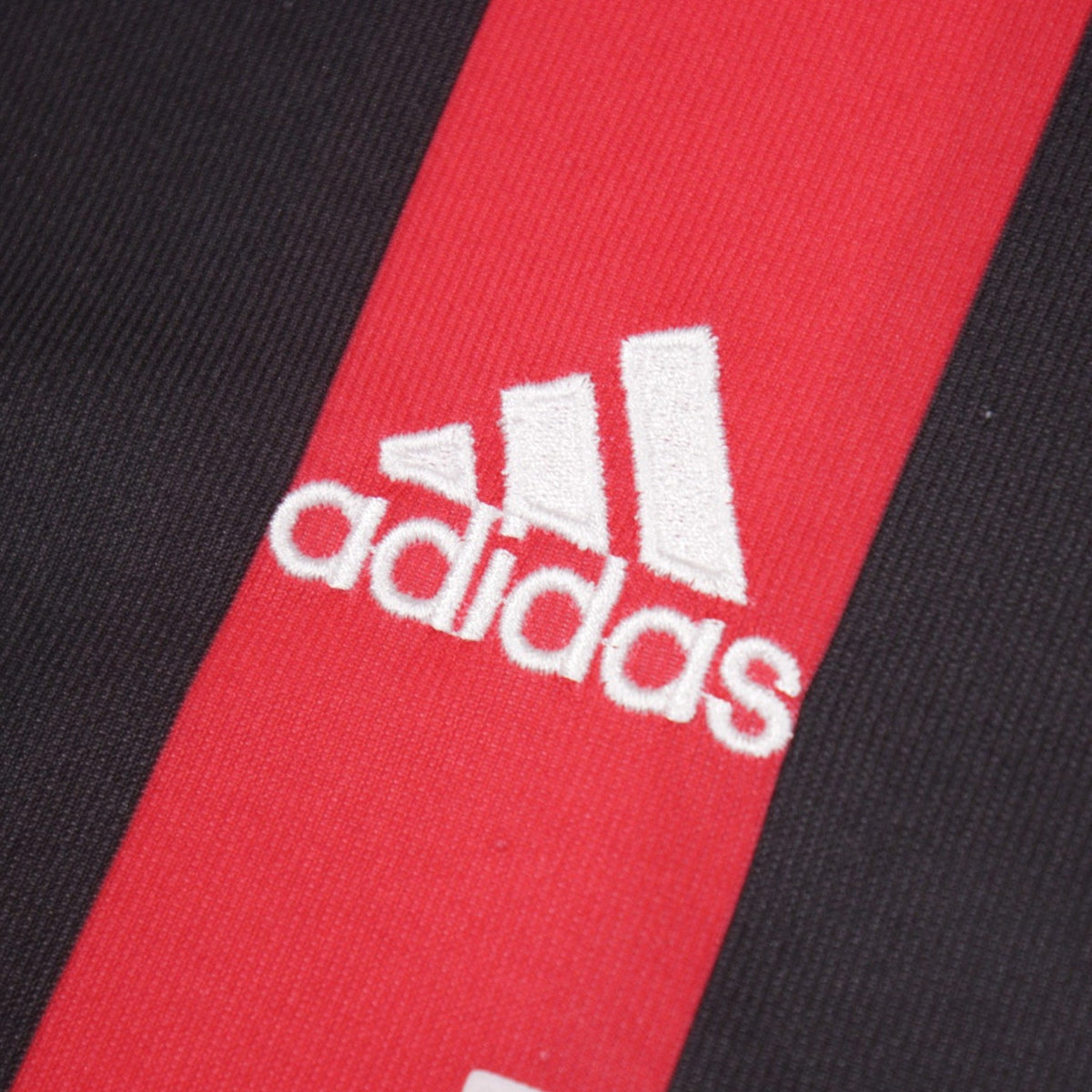 Close-up of the adidas logo on the chest stripe