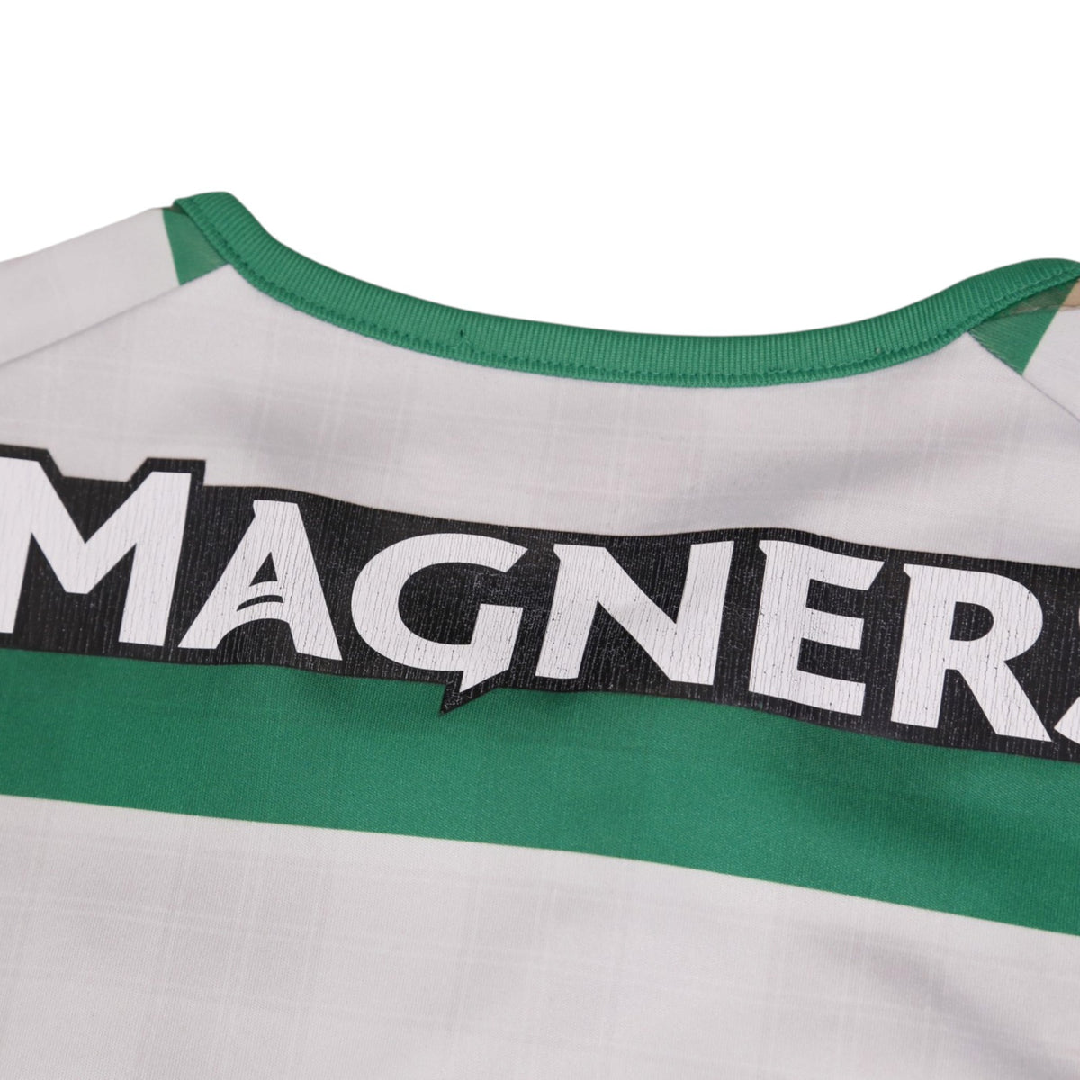 Close-up of the Magners sponsor text and green collar trim on the Celtic shirt