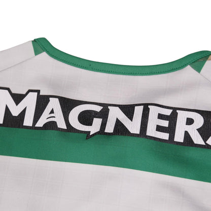 Close-up of the Magners sponsor text and green collar trim on the Celtic shirt