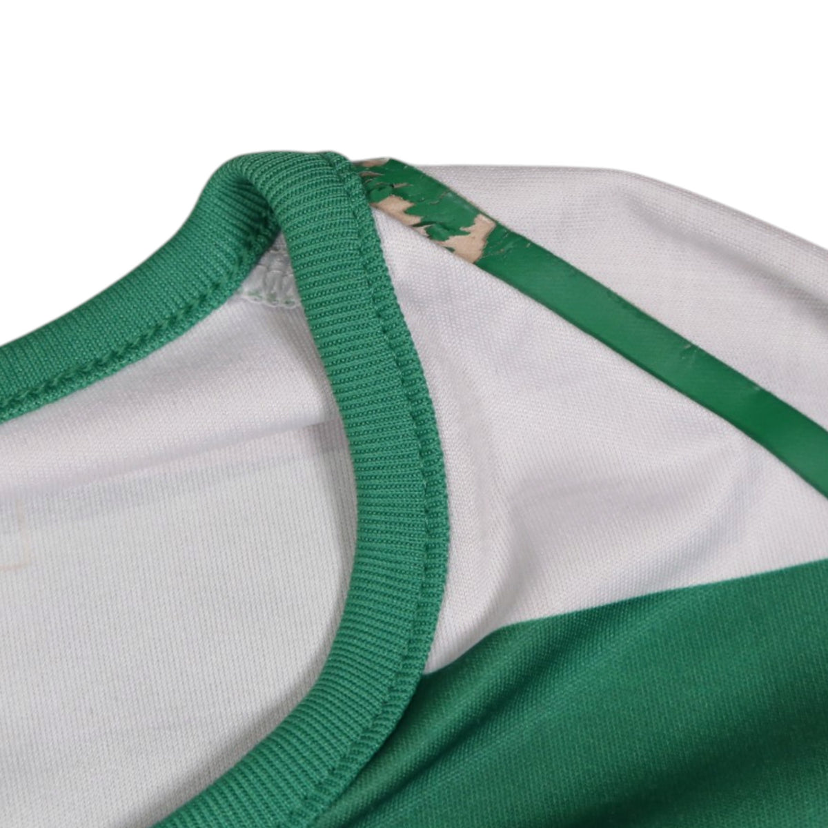Close-up of cracking on the green shoulder trim strap of the Celtic shirt