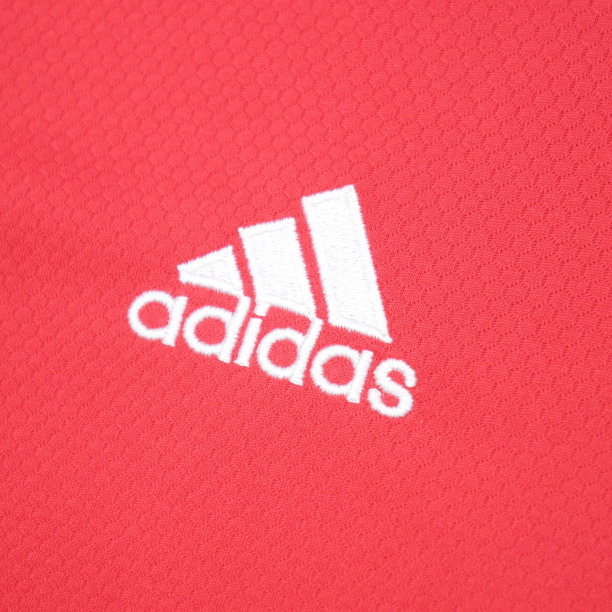 Close-up of adidas logo on shirt fabric