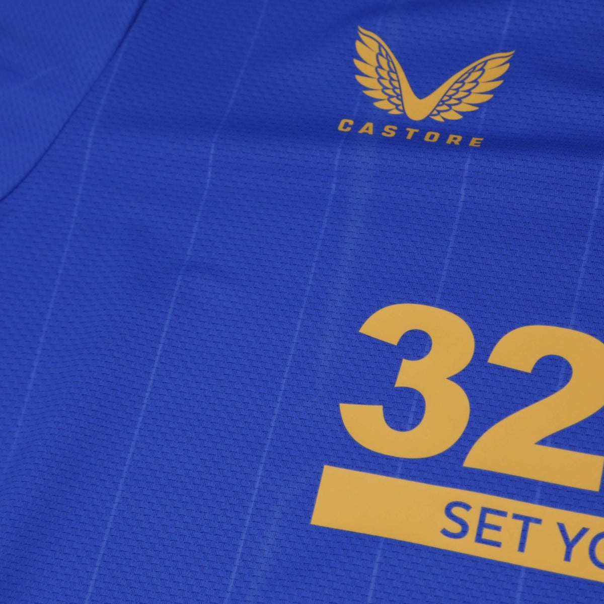 Close-up of Castore logo and 32Red sponsor print on chest