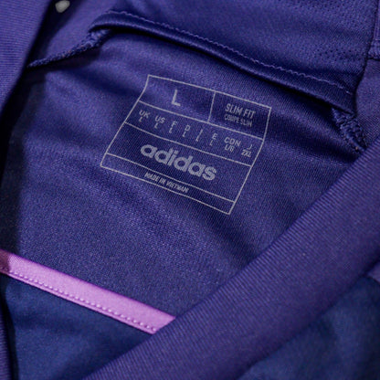 Close-up of the adidas neck label showing size L