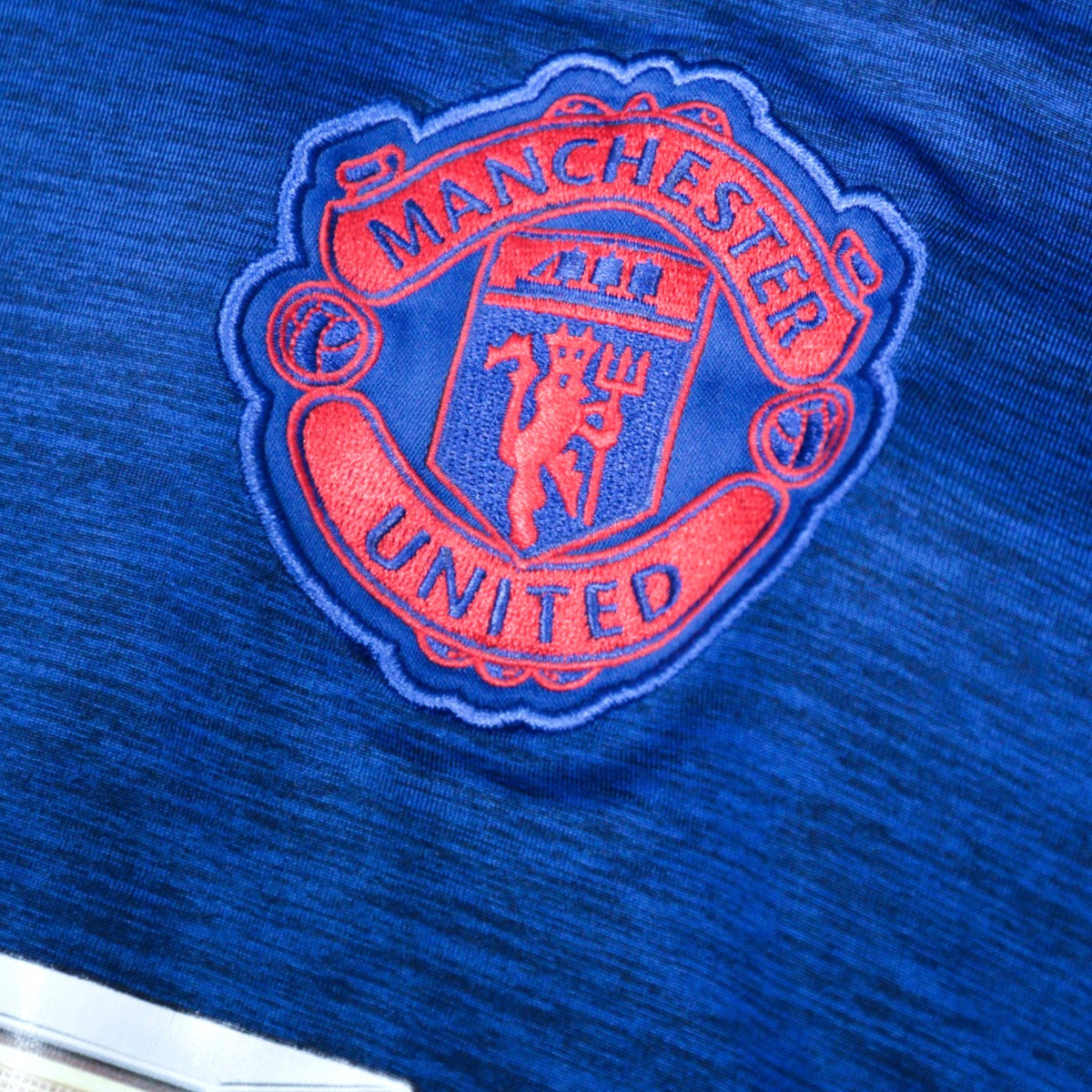 Close-up of embroidered Manchester United crest on the chest