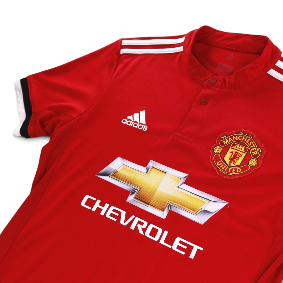 Close-up of adidas logo, Manchester United crest and Chevrolet sponsor on the chest
