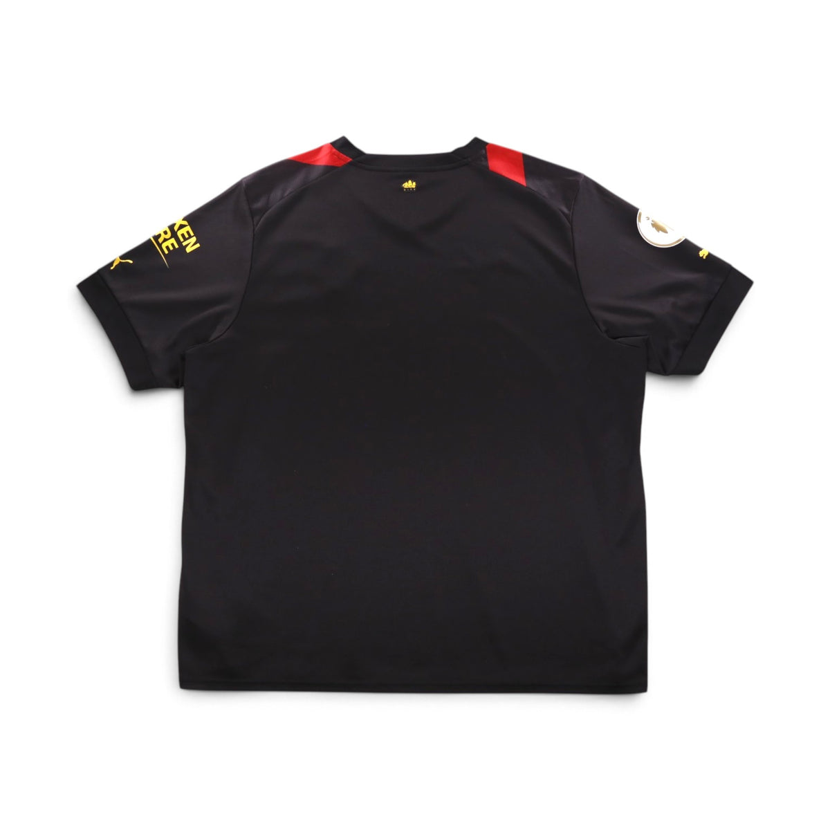 Back of black Manchester City away shirt with red panels at the shoulders