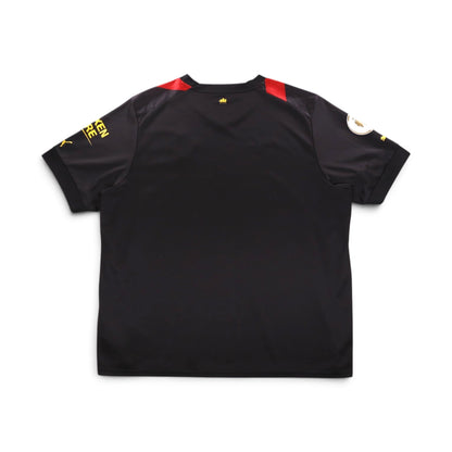 Back of black Manchester City away shirt with red panels at the shoulders