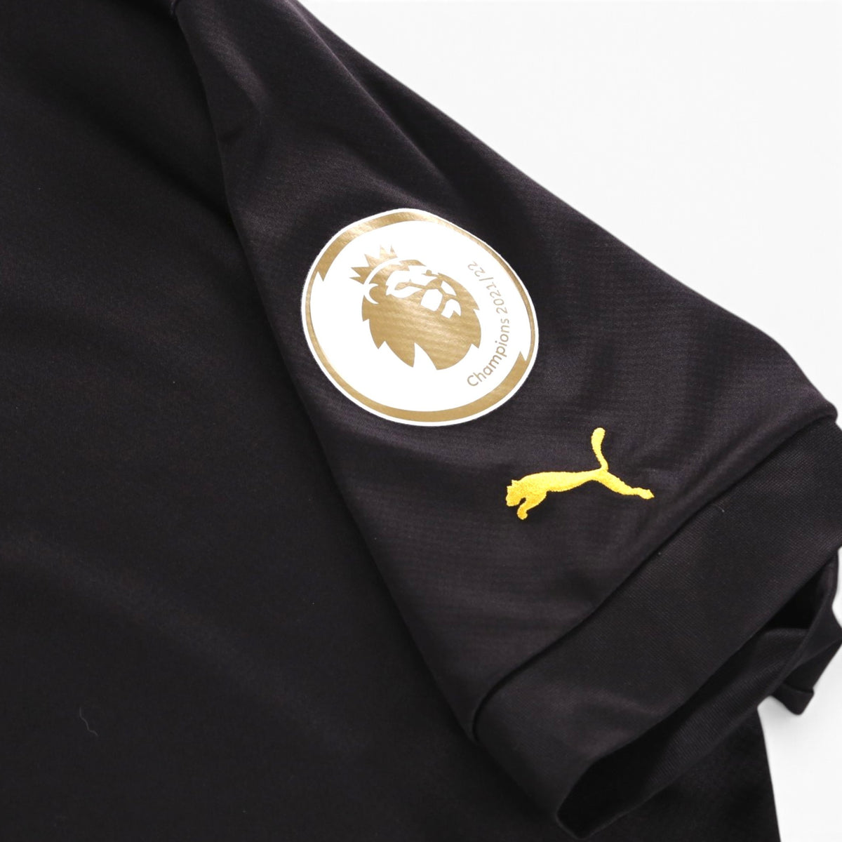 Close-up of Premier League champions 2021/22 patch and Puma logo on the sleeve
