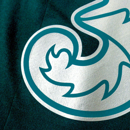 Close-up of the Three sponsor logo printed on the chest of the home shirt