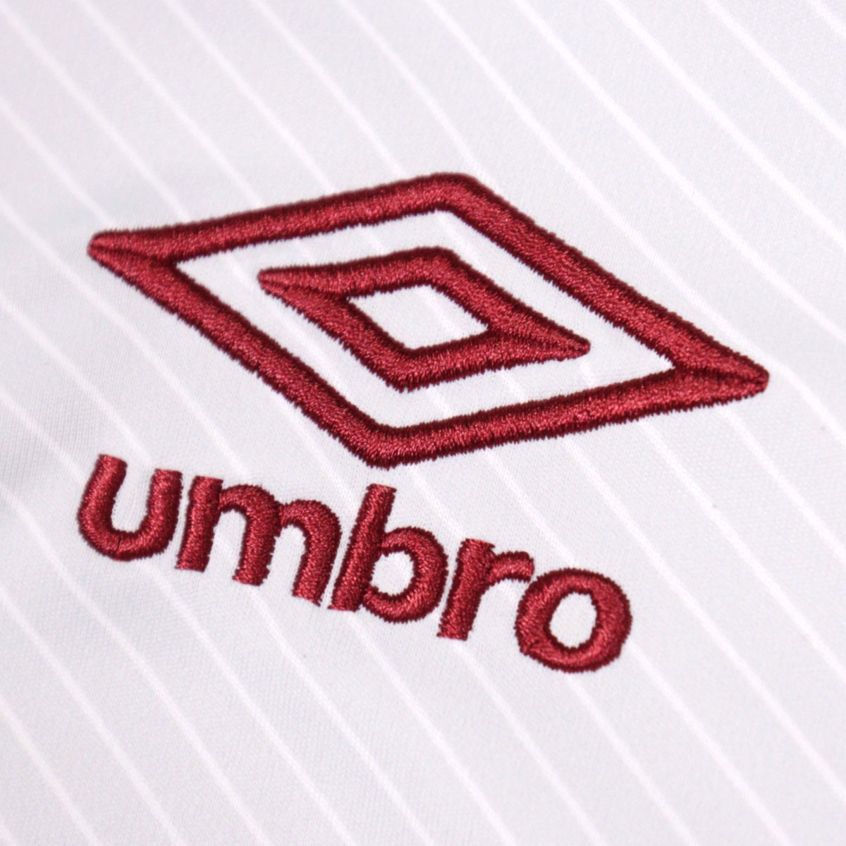 Close-up of the embroidered Umbro logo on the shirt