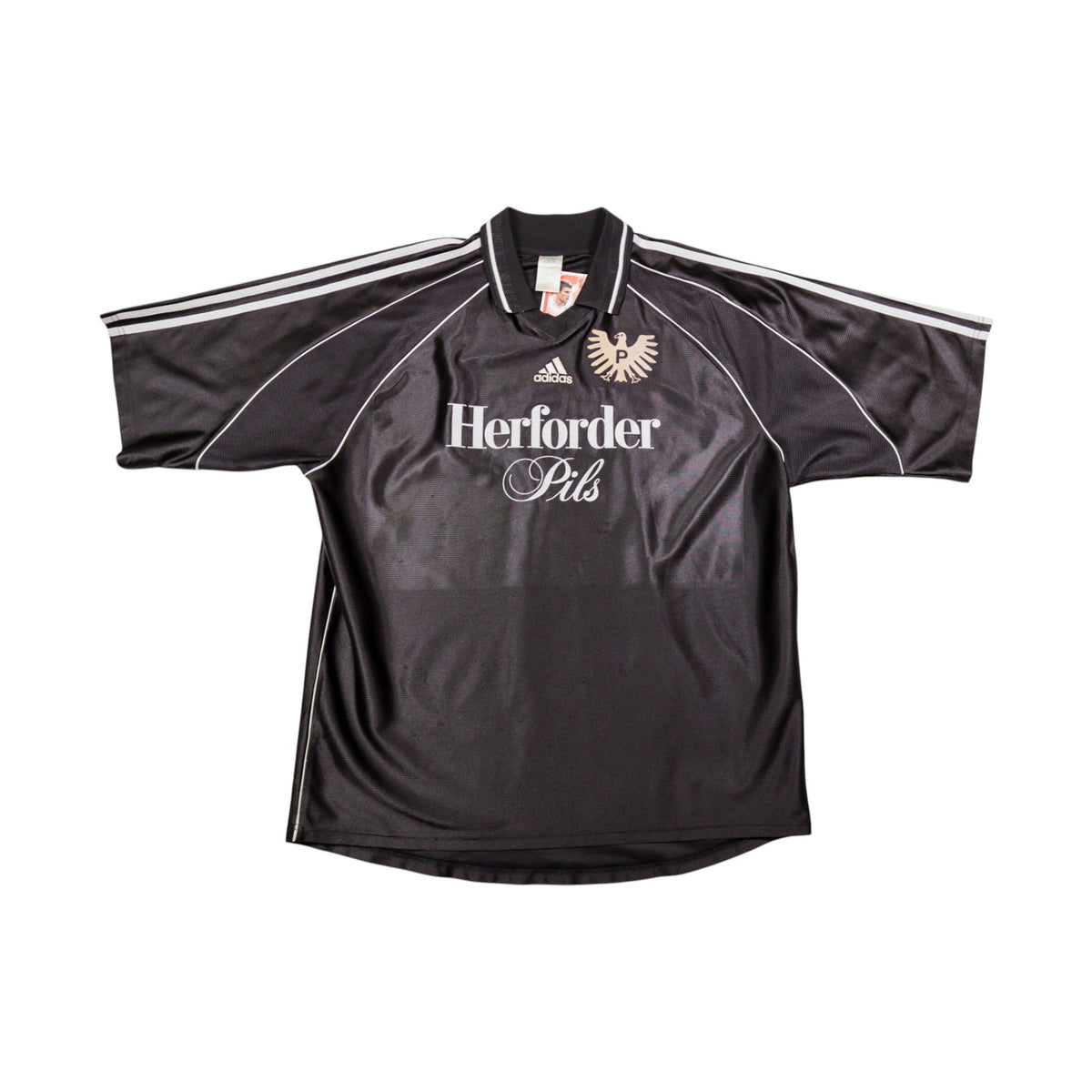 Front of black Preußen Münster away shirt with Herforder Pils sponsor and adidas logo