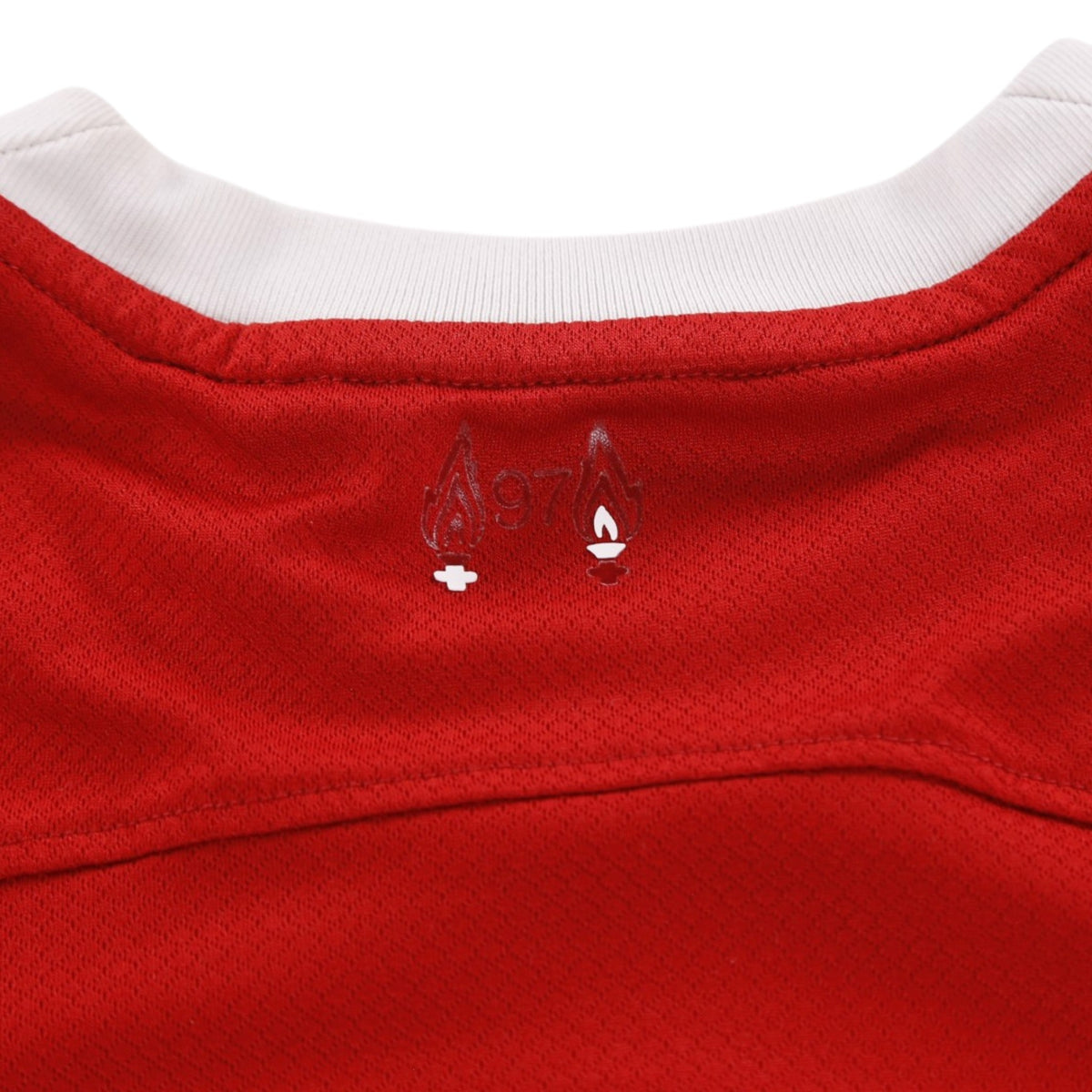 Close-up of commemorative 97 flames detail below the back collar