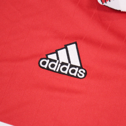 Close-up of the adidas logo embroidered on the shirt