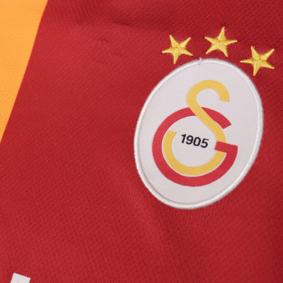 Close-up of the Galatasaray crest with three championship stars
