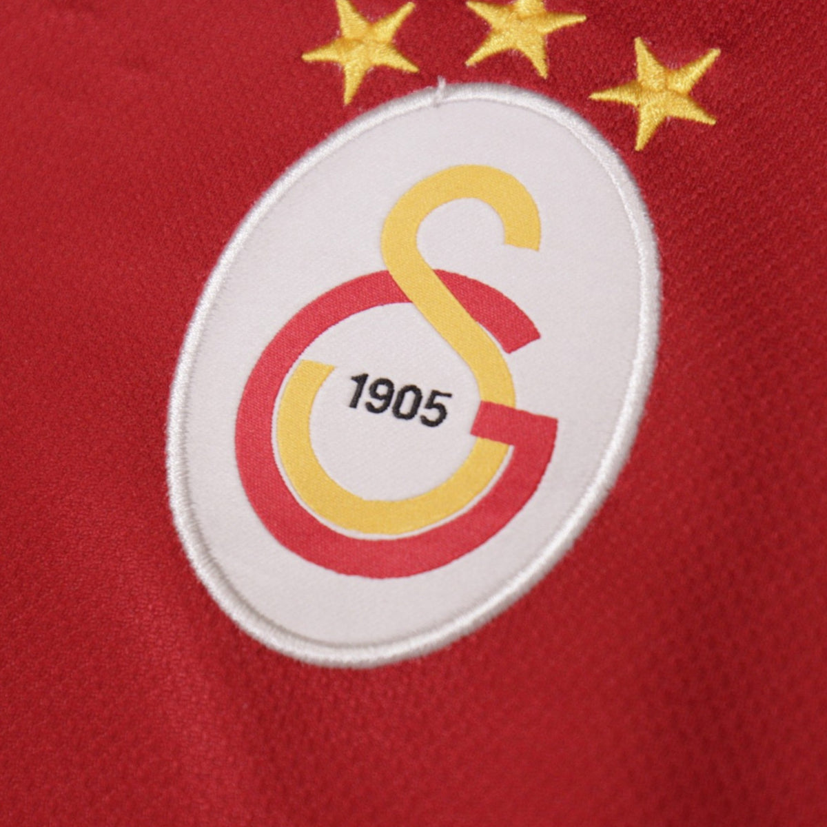 Close-up detail of the Galatasaray crest on the shirt