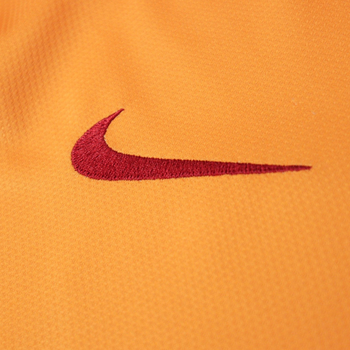 Close-up of the Nike swoosh logo on the shirt