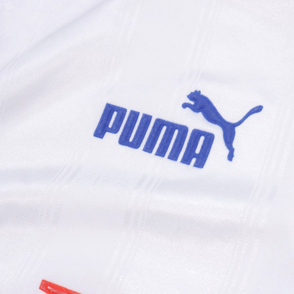 Close-up of the Puma logo on the shirt fabric