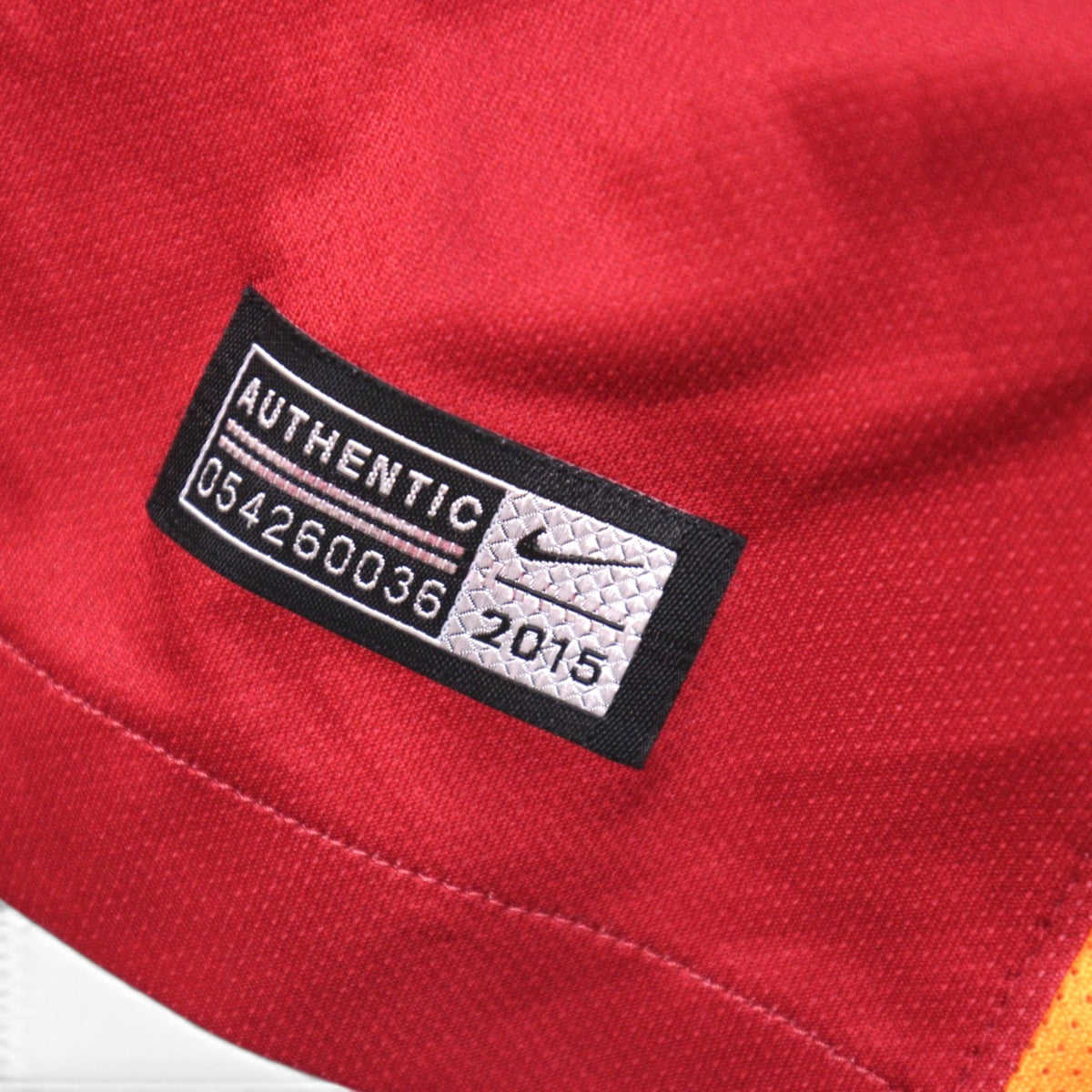 Close-up of the Nike Authentic neck label reading 054260036 2015