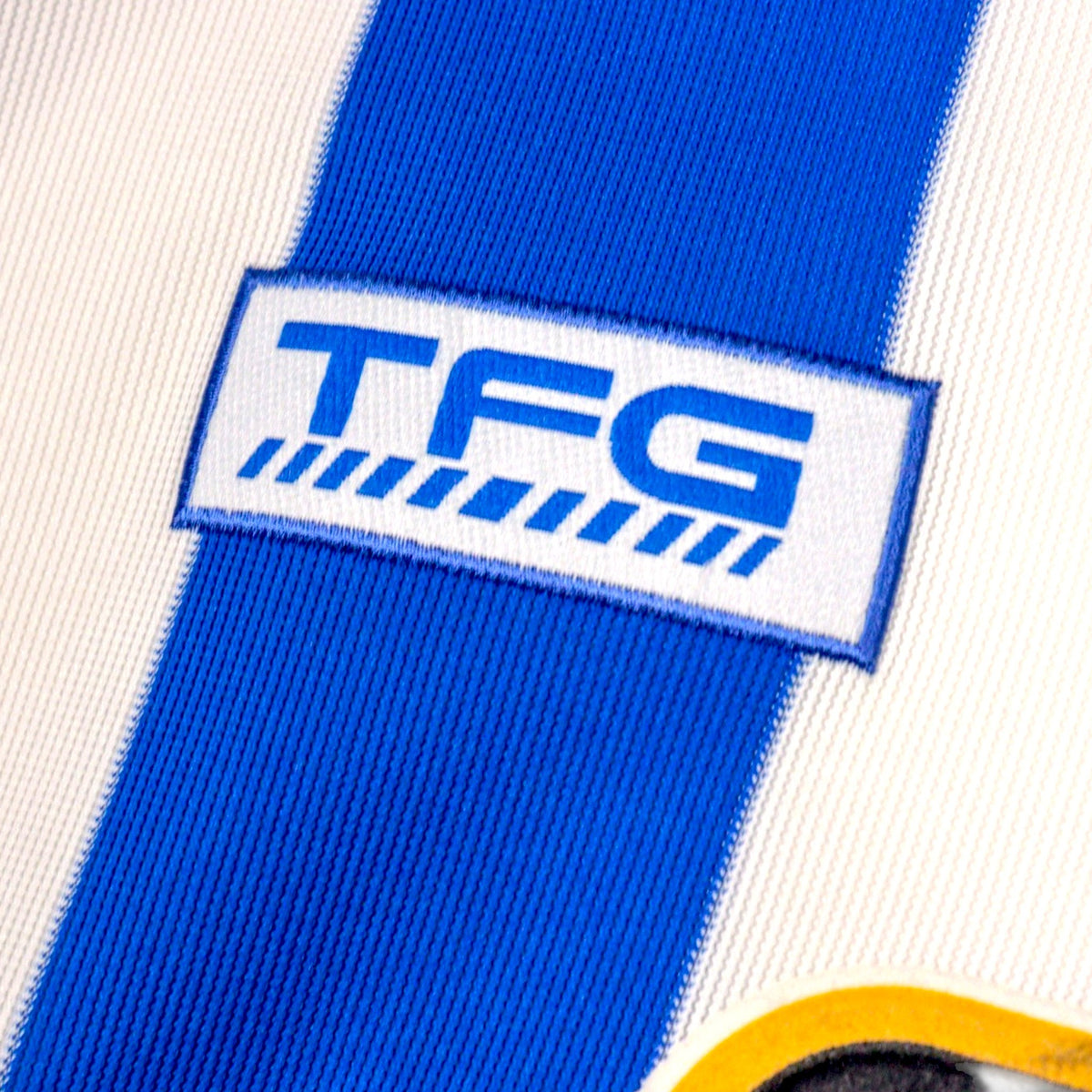Close-up of the TFG manufacturer logo on the chest