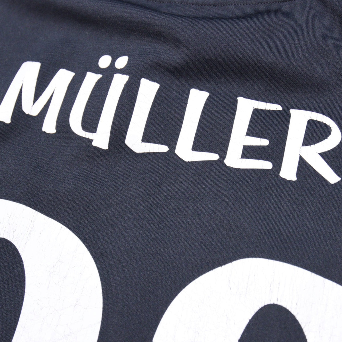 Close-up of Müller name print showing light surface cracking