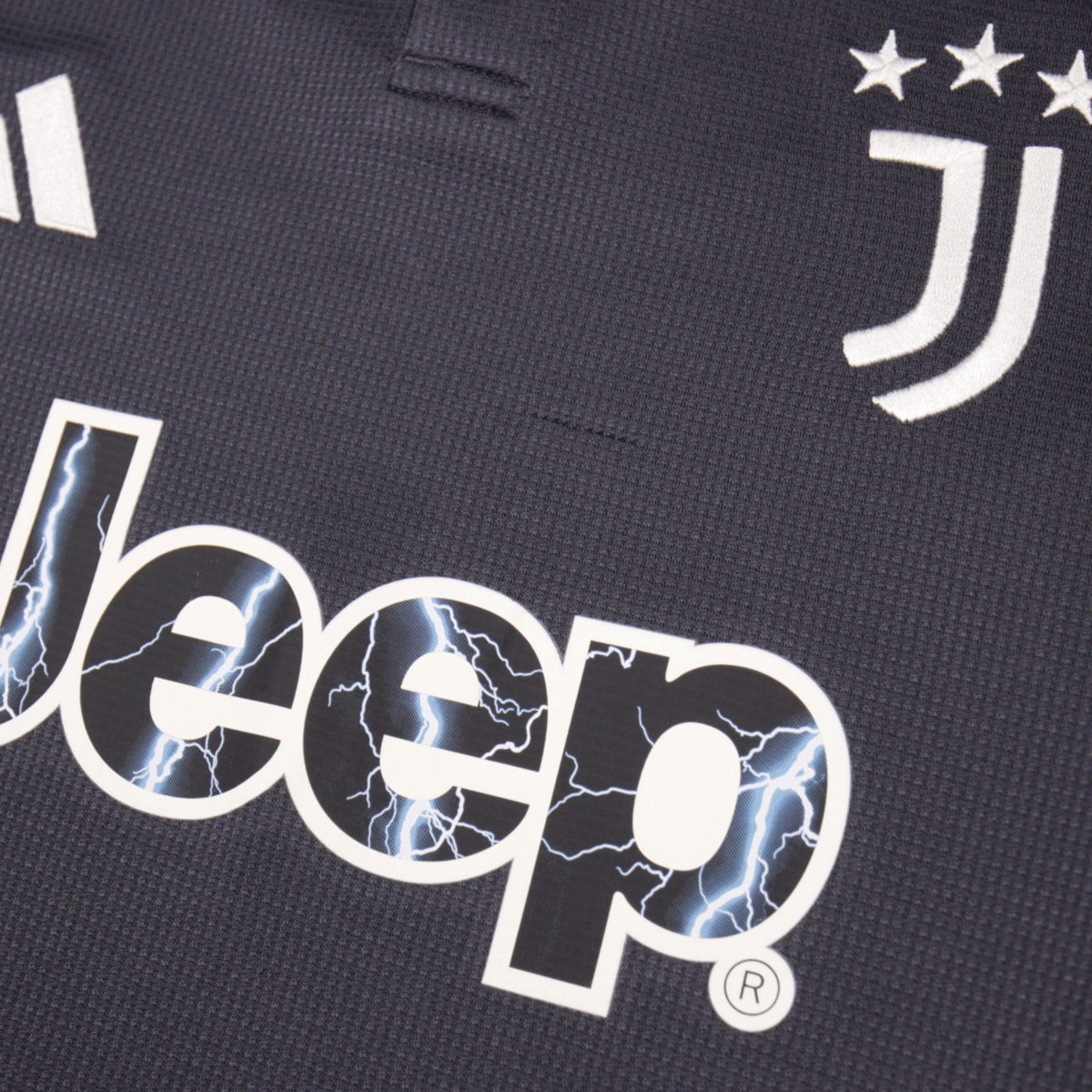 Close-up of Juventus crest, three stars and Jeep sponsor logo on the third shirt