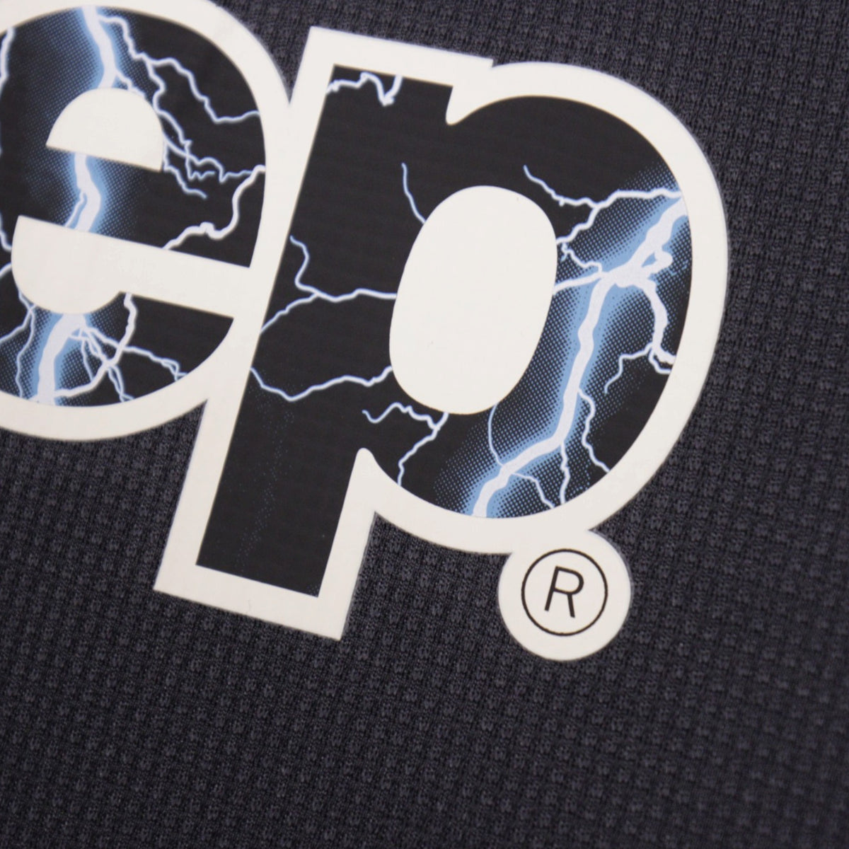 Close-up detail of the Jeep sponsor logo lightning-bolt print texture