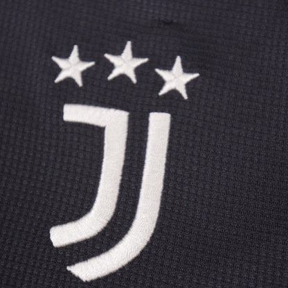 Close-up of the embroidered Juventus crest and three stars on the third shirt