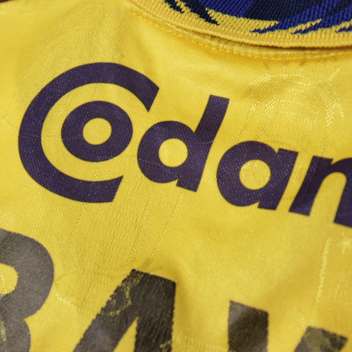 Close-up of Codan sponsor print and name on shirt back