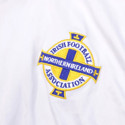 Detail of the embroidered Irish Football Association crest on white shirt fabric