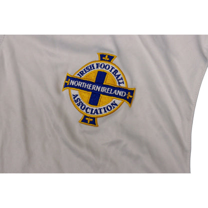 Close-up of embroidered Northern Ireland crest on white shirt fabric