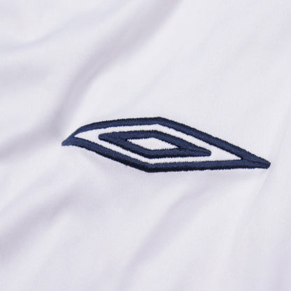 Close-up of the Umbro diamond logo on the shirt sleeve