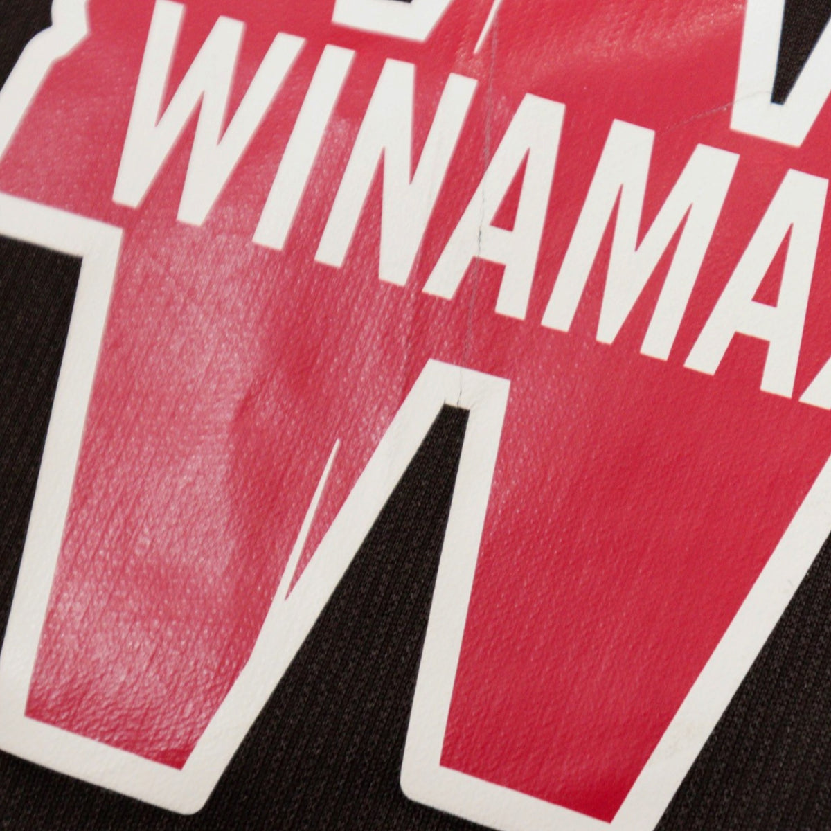 Close-up of the Winamax chest print showing a fine crease line