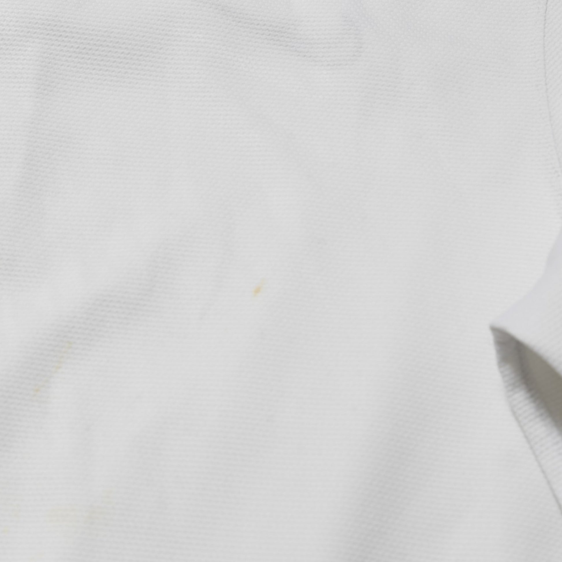 Close-up of fabric showing minor mark on France away shirt