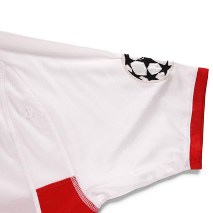 Close-up of sleeve showing UEFA Champions League patch and red trim