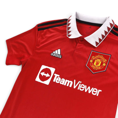 Close-up of adidas Manchester United home shirt collar, crest and sponsor detail