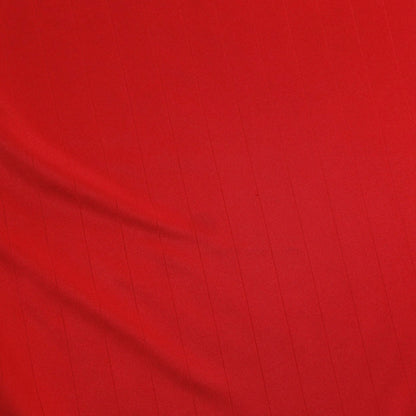 Close-up of red fabric texture of the Manchester United home shirt