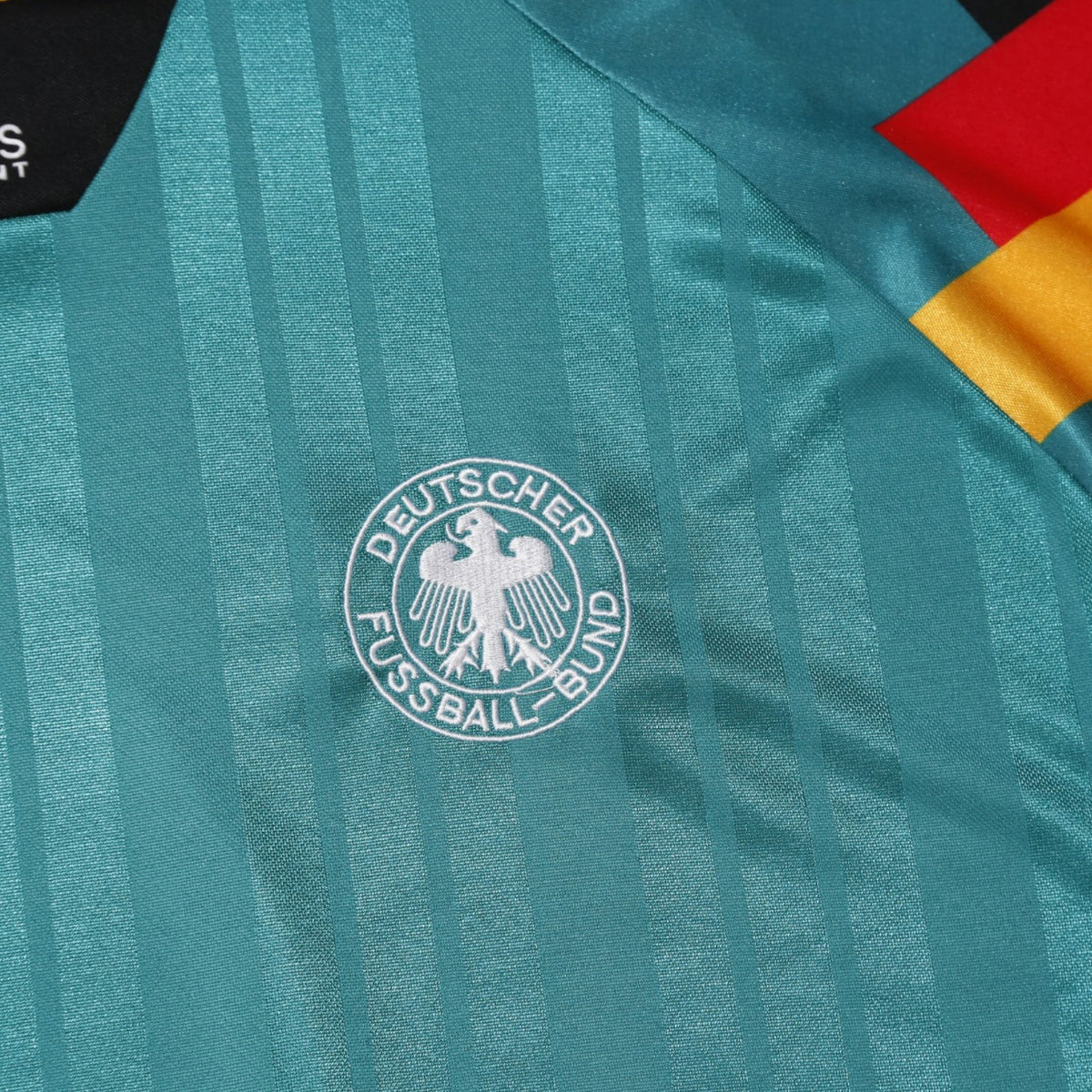Close-up of adidas Equipment label and XL size tag on collar